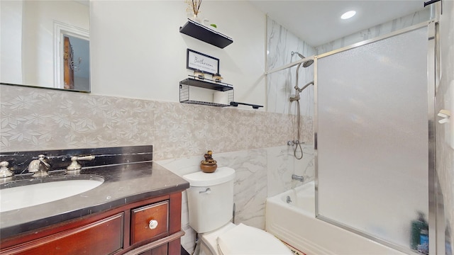 full bathroom with toilet, backsplash, vanity, and shower / bath combination with glass door