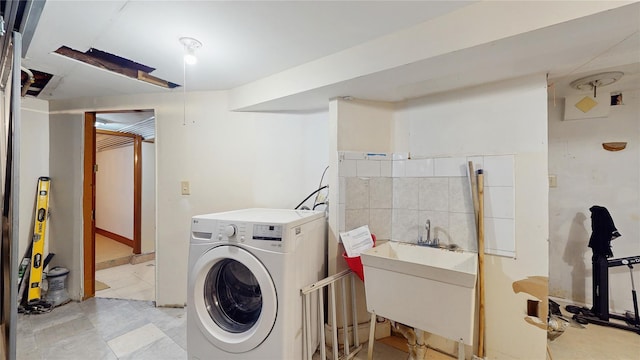 laundry room featuring sink and washer / dryer