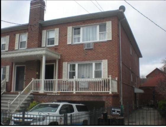 back of house featuring covered porch