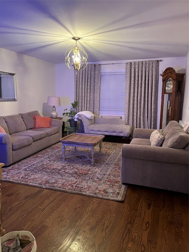 living room featuring dark wood-type flooring and a chandelier