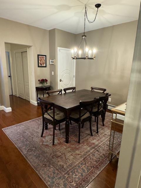 dining space featuring dark hardwood / wood-style flooring and a notable chandelier