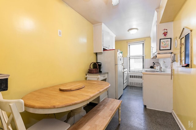 dining room featuring sink and radiator heating unit