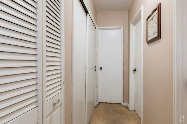 hallway featuring light colored carpet