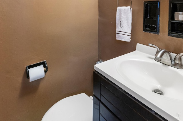 bathroom with toilet and vanity