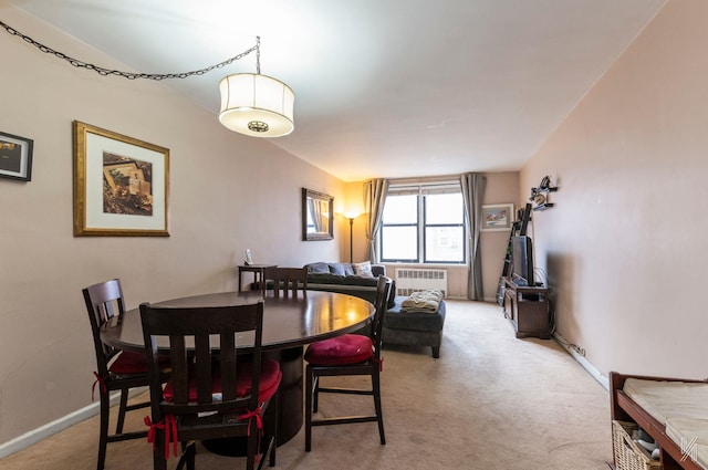 carpeted dining area with radiator heating unit