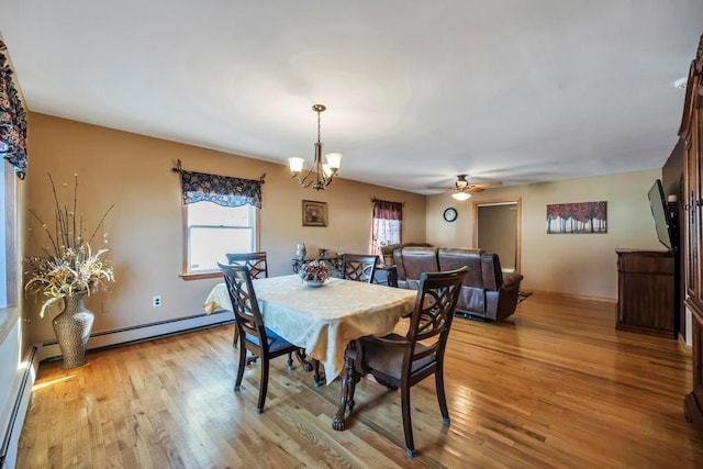 dining room with baseboard heating, light hardwood / wood-style floors, and ceiling fan with notable chandelier