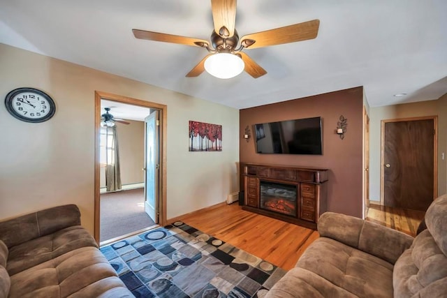 living room featuring hardwood / wood-style flooring and a baseboard heating unit