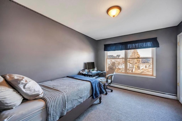 carpeted bedroom featuring a baseboard heating unit