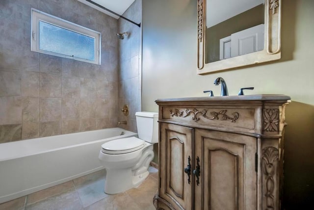 full bathroom featuring tiled shower / bath combo, toilet, and vanity