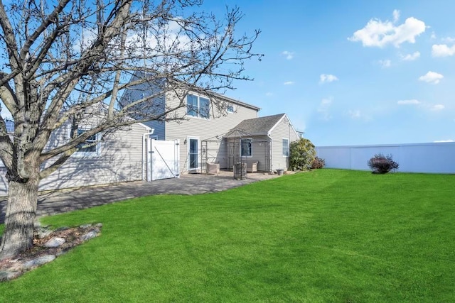 rear view of house with a yard