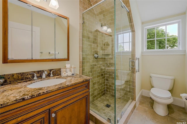 bathroom with a shower with shower door, toilet, vanity, and tile patterned flooring