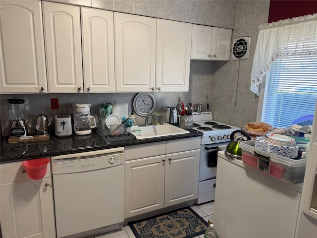 kitchen featuring white appliances, white cabinets, decorative backsplash, sink, and light tile patterned floors