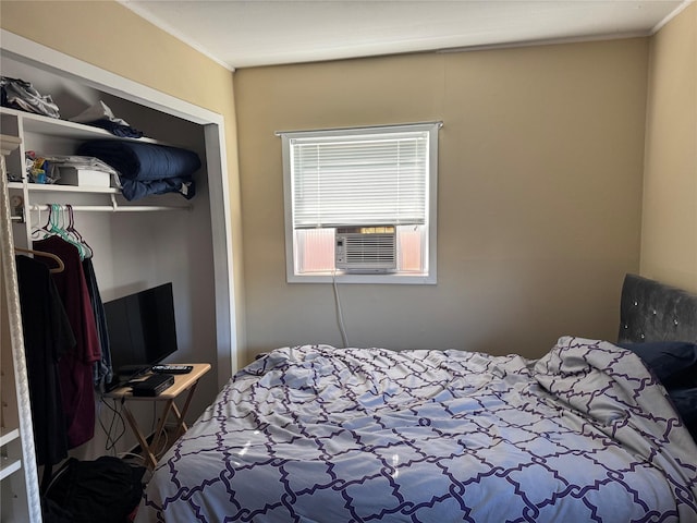 bedroom featuring a closet, ornamental molding, and cooling unit