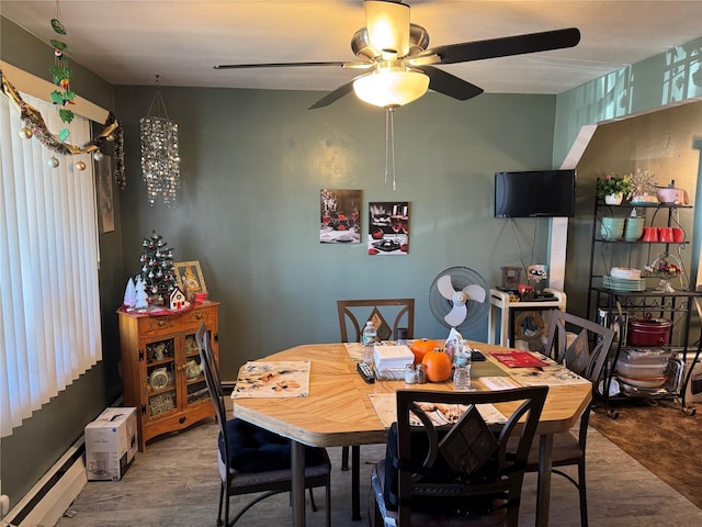 dining room with baseboard heating and wood-type flooring