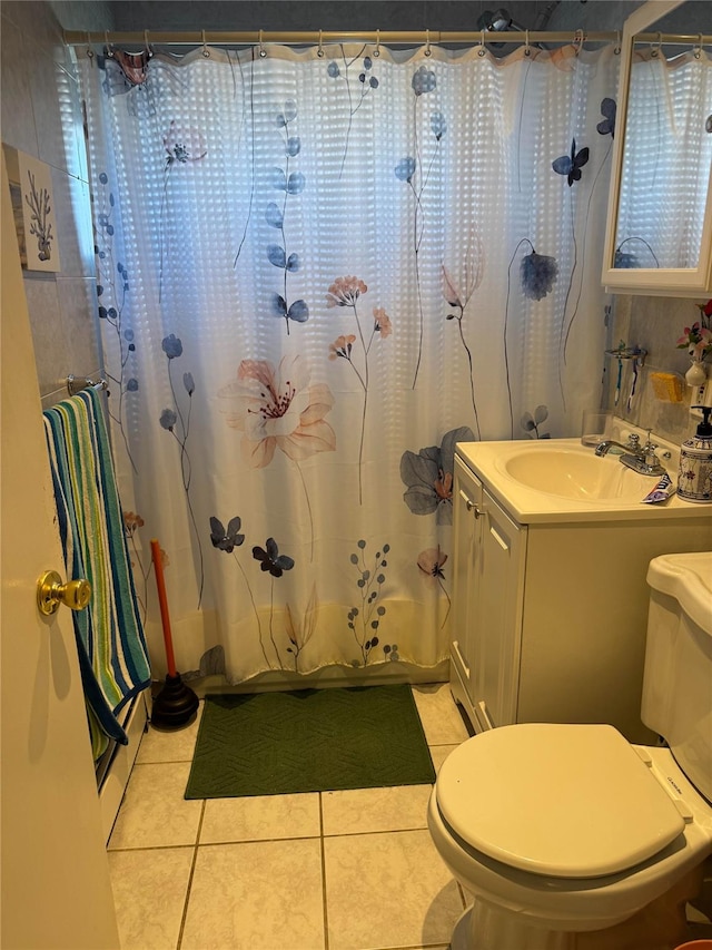 bathroom with tile patterned floors, vanity, and toilet