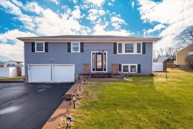 bi-level home featuring a garage and a front yard