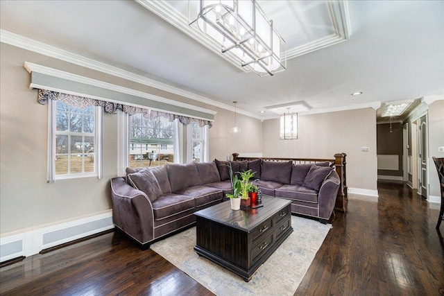 living room with crown molding, hardwood / wood-style floors, and a notable chandelier