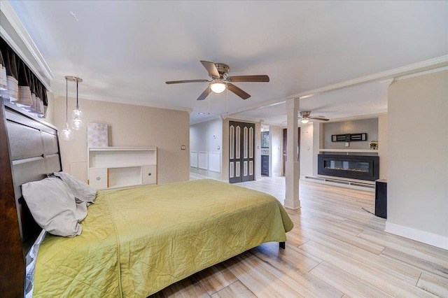 bedroom with ceiling fan, ornamental molding, and light hardwood / wood-style flooring