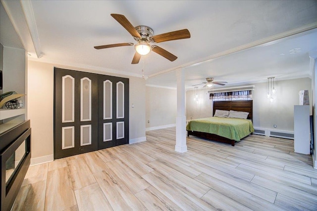 bedroom with crown molding, ceiling fan, baseboard heating, and light hardwood / wood-style flooring