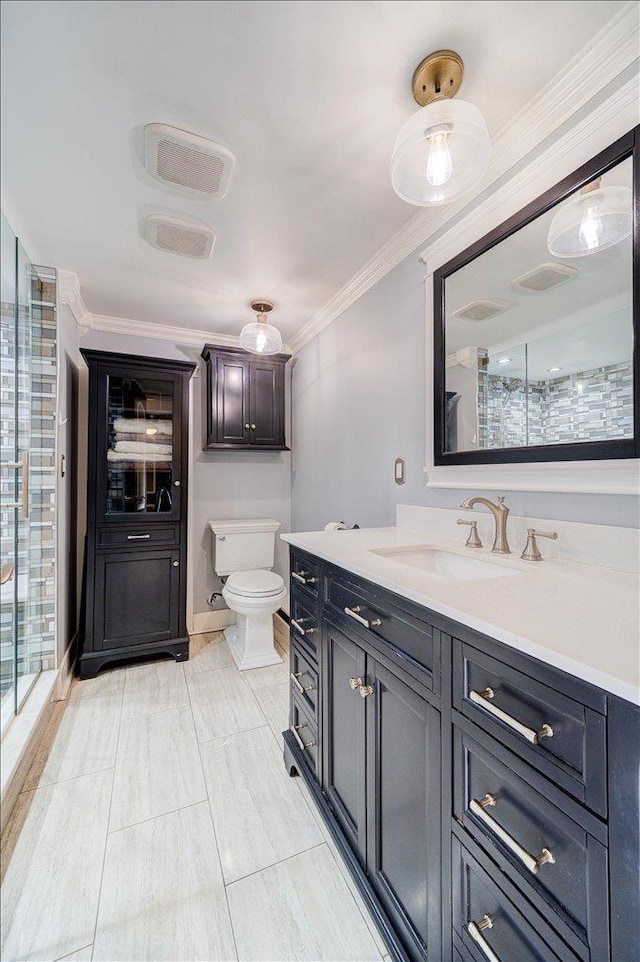 bathroom featuring vanity, crown molding, toilet, and walk in shower