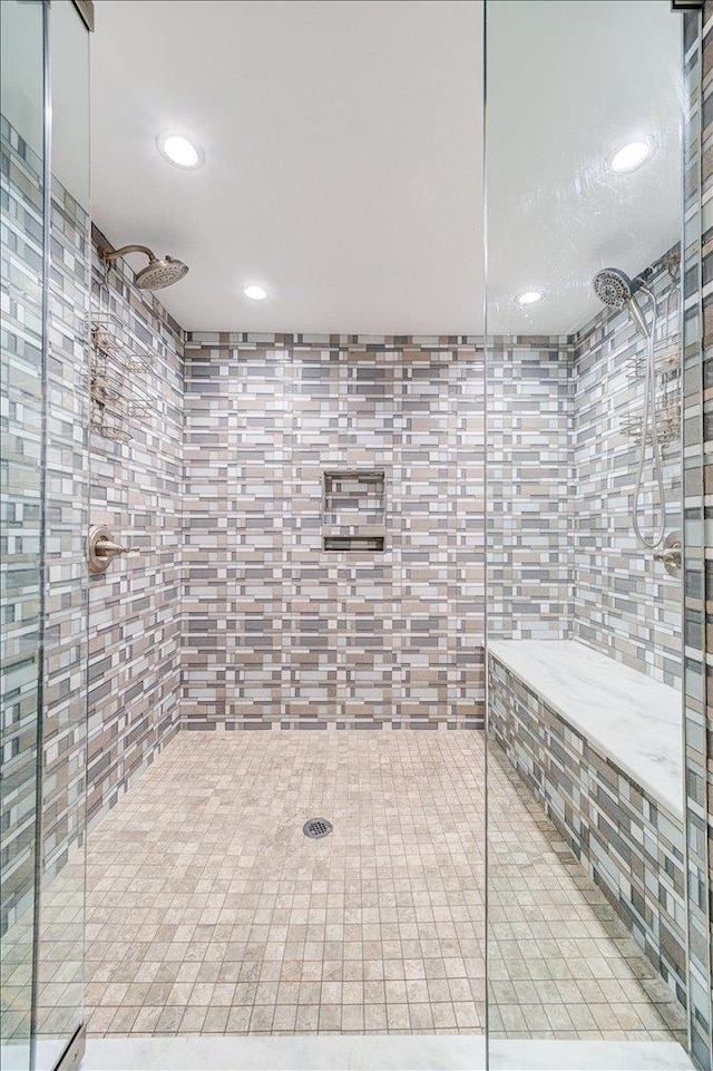 bathroom with tile walls and tiled shower