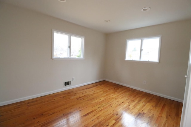 spare room with light hardwood / wood-style flooring