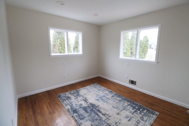 spare room featuring dark hardwood / wood-style floors