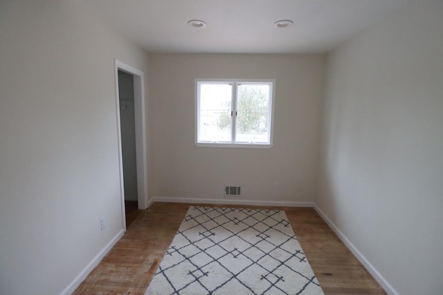 spare room featuring hardwood / wood-style floors