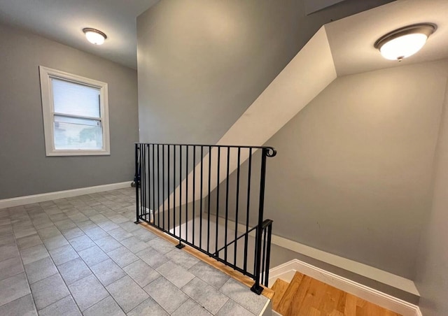 stairway with vaulted ceiling