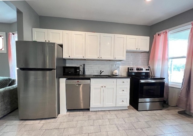 kitchen with sink, stainless steel appliances, and white cabinetry