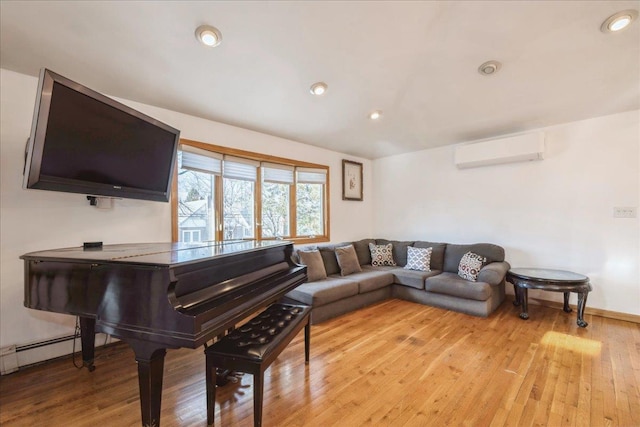 miscellaneous room featuring light hardwood / wood-style floors, baseboard heating, and a wall mounted air conditioner