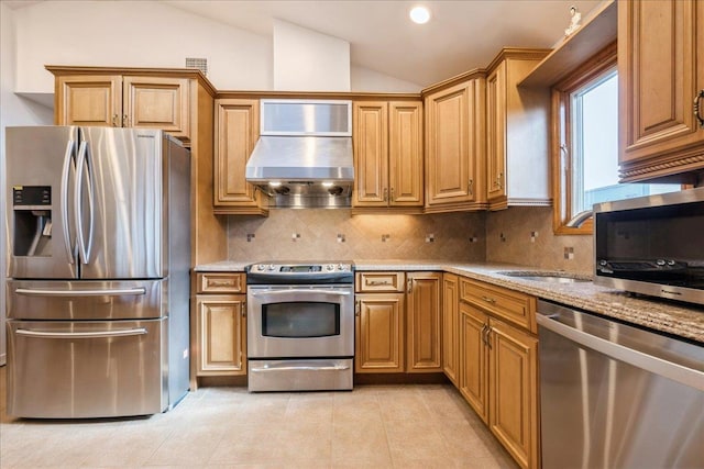 kitchen with light stone countertops, lofted ceiling, stainless steel appliances, decorative backsplash, and range hood