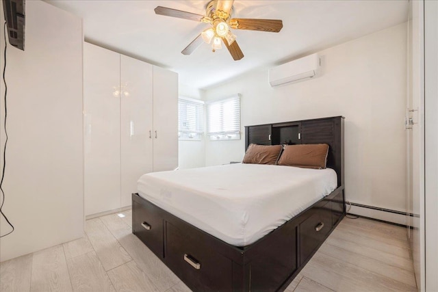 bedroom featuring ceiling fan, baseboard heating, light hardwood / wood-style flooring, and a wall mounted air conditioner