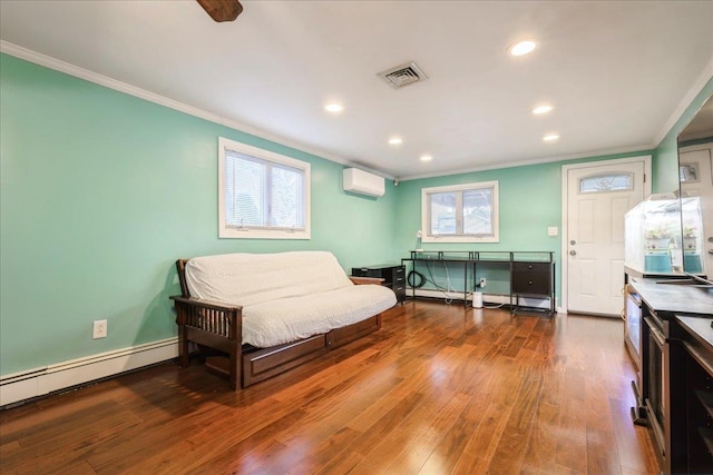 bedroom with an AC wall unit, multiple windows, hardwood / wood-style flooring, and ornamental molding