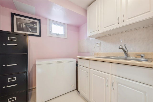 washroom featuring cabinets, sink, and light tile patterned flooring