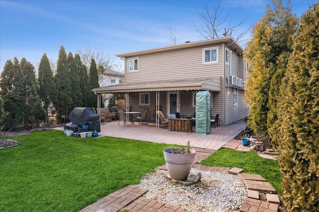 back of property featuring a yard and a patio