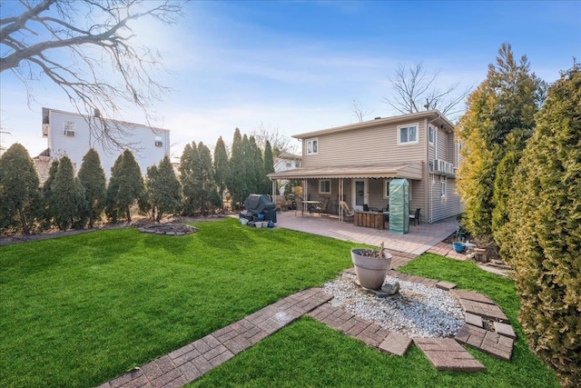 rear view of house with a patio and a yard