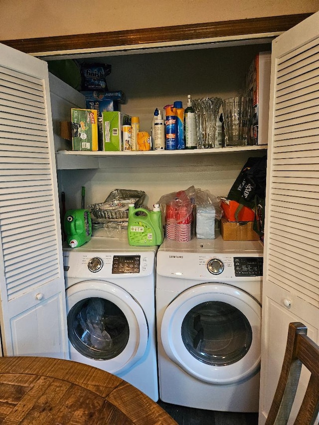 clothes washing area with washer and clothes dryer