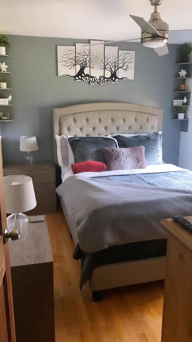 bedroom with ceiling fan and wood-type flooring