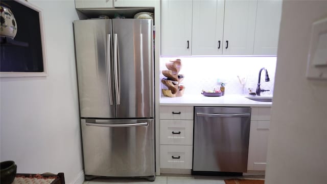 kitchen with white cabinets, appliances with stainless steel finishes, and sink