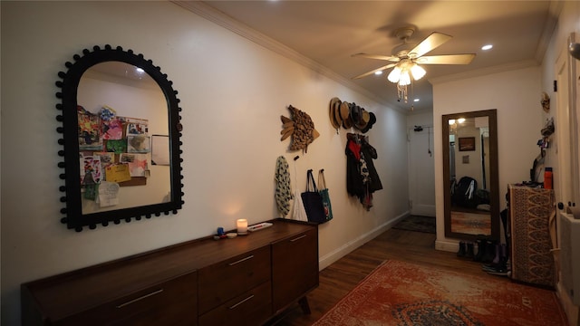 hall with dark wood-type flooring and ornamental molding