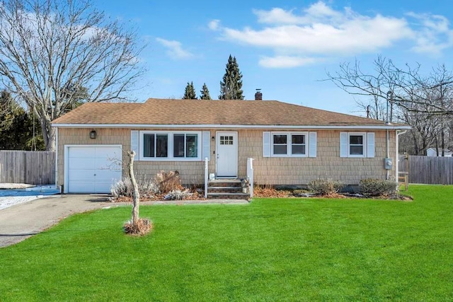 single story home featuring a garage and a front yard