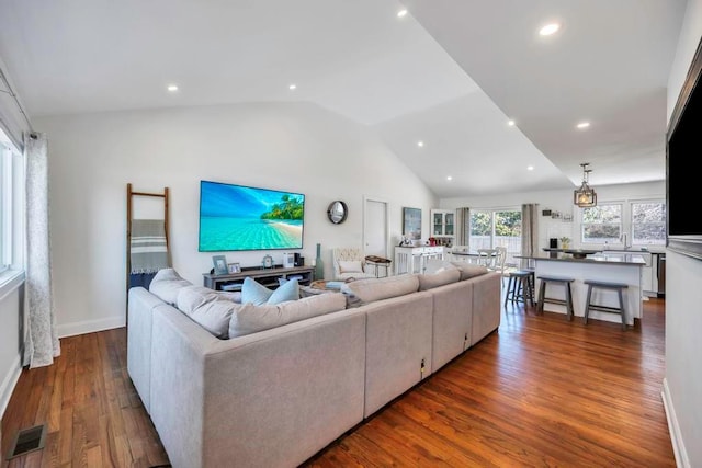 living room with lofted ceiling and dark hardwood / wood-style floors