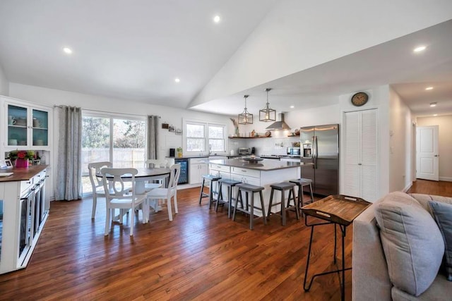 dining room featuring dark hardwood / wood-style flooring and high vaulted ceiling