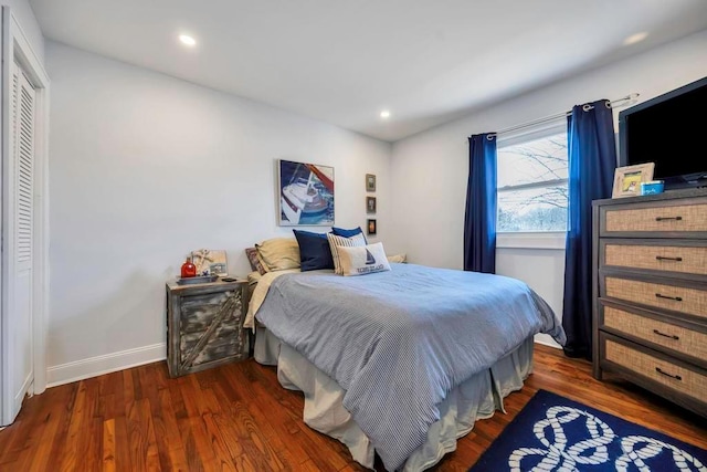 bedroom featuring dark hardwood / wood-style flooring and a closet