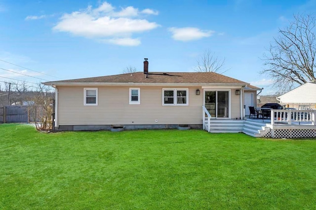 rear view of property with a wooden deck and a yard