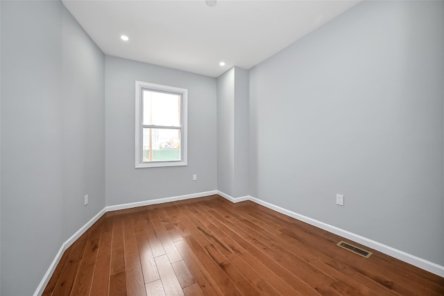 spare room featuring wood-type flooring