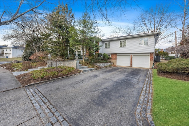 view of front of property featuring central AC and a garage