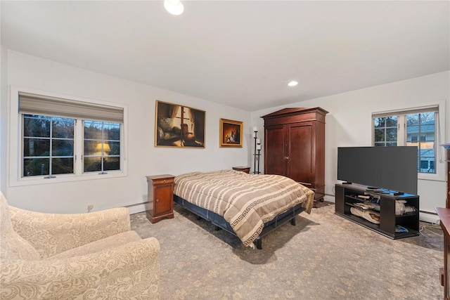 bedroom with a baseboard radiator and light carpet