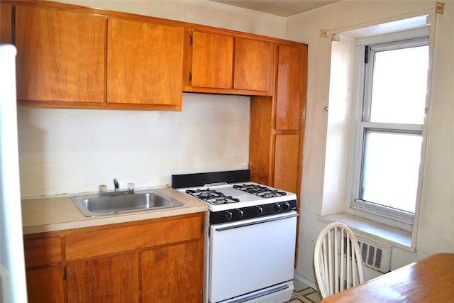 kitchen featuring white range with gas stovetop and sink